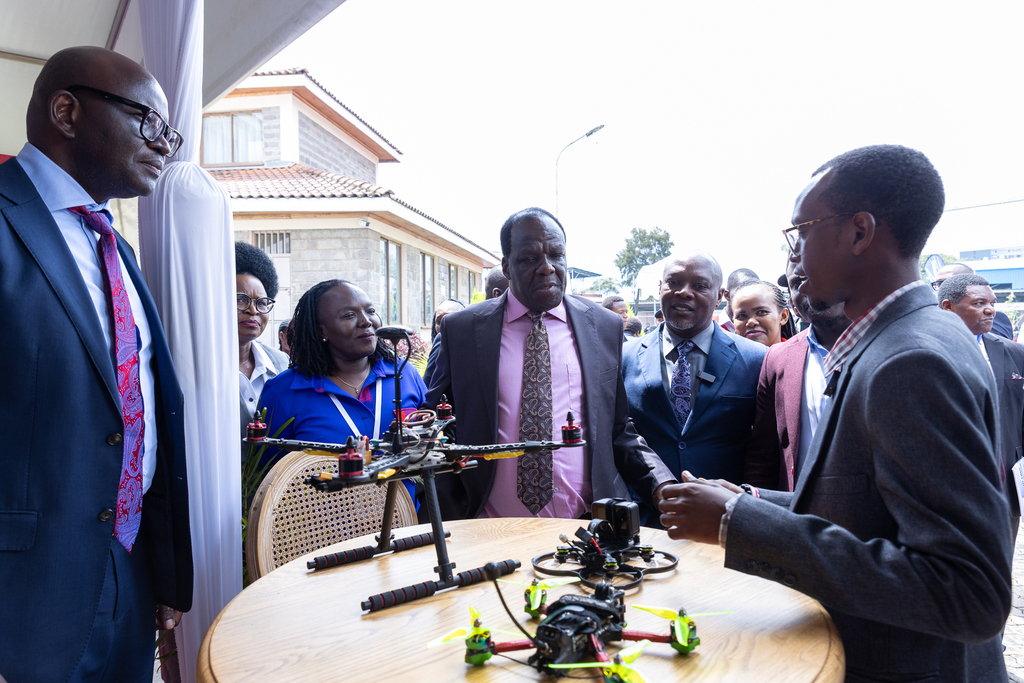 Equity Bank Kenya Managing Director, Moses Nyabanda, KEPSA Director of SMEand Start-Ups Mary Ngechu; MSMEs Development, Cabinet Secretary, Wycliffe Oparanya; and Equity Bank Kenya Director for SMEs, Collins Wanyonyi follow a demonstration of drone operation by Dronector Limited Founder and CEO Kevin Githinji (near right) at the Equity tent during the MSME Day 2025 marked in Nairobi